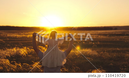 Papa brought little lovely daughter to train sports at sunset on field Papa brought little lovely daughter to train sports at sunset on field 110419720