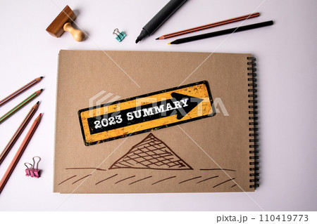 2023 year summary. Text in a spiral notebook on a white office table 2023 year summary. Text in a spiral notebook on a white office table 110419773
