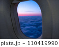 Amazing view of clouds and sunset in window on an airplane.  110419990