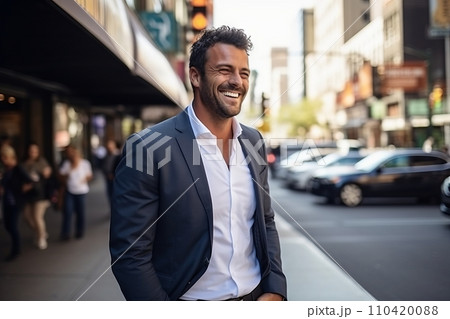 Portrait of a handsome Hispanic businessman smiling while walking in a city. 110420088