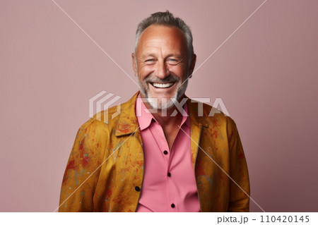 Portrait of a happy senior man smiling and looking at camera while standing against pink background. 110420145