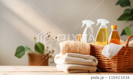 AI-generated content. Various detergents for washing and cleaning, colored towels in wicker basket, on light tabletop with green plants AI-generated content. Various detergents for washing and cleaning, colored towels in wicker basket, on light tabletop with green plants 110421016