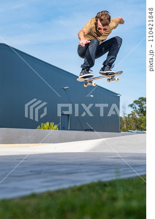 Skateboarder doing ollie trick 110421848