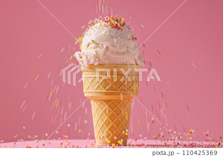 vanilla ice cream ball with falling sugar sprinkles 110425369