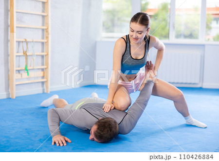 Young girl and middle-aged man practicing arm twist technique during self-defense courses Young girl and middle-aged man practicing arm twist technique during self-defense courses 110426884