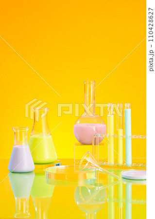 Laboratory glassware containing color solution decorated on a yellow background.Empty space on glass podium for product presentation. Science laboratory research and development concept 110428627