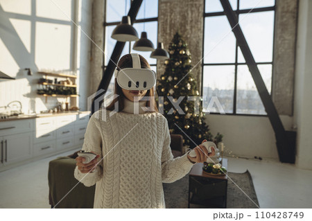 Sharing her thoughts, a stunning girl in a virtual reality headset discusses her impressions. 110428749