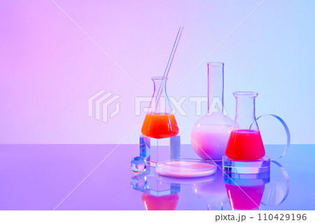Transparent glass platforms are displayed with experimental flasks on a purple-blue gradient background. Empty space for product display. Research concept. 110429196