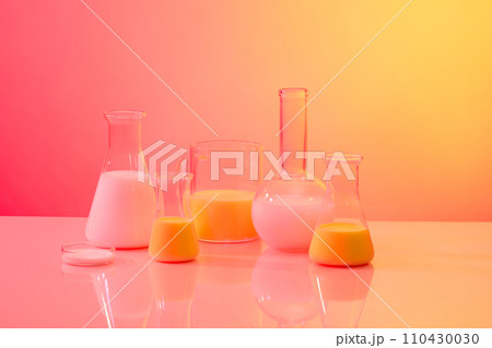 A flat-bottom florence flask, petri dish, a mug and conical flasks of liquid arranged on gradient background. Research science content 110430030