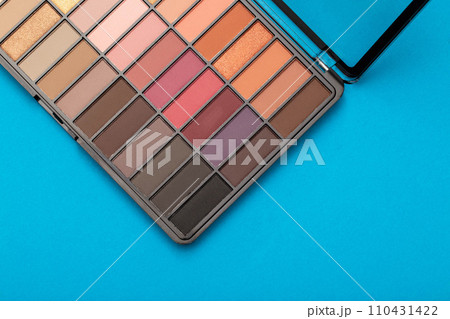 A set of modern eye shadows with powdery shades on a blue background. Soft texture and shading, brand, close-up. Copy space for text A set of modern eye shadows with powdery shades on a blue background. Soft texture and shading, brand, close-up. Copy space for text 110431422