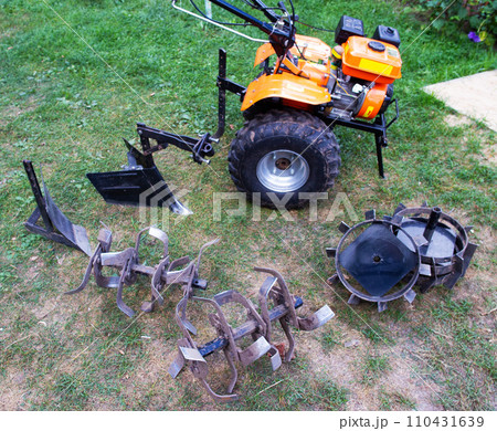Agricultural walk-behind tractor with a set of attachments, hiller, milling cutters and lugs. Two-wheel tractor, industry 110431639