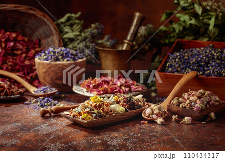 Various dried medicinal plants on a brown background. Various dried medicinal plants on a brown background. 110434317