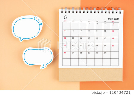 May 2024 desk calendar and empty speech bubble. 110434721