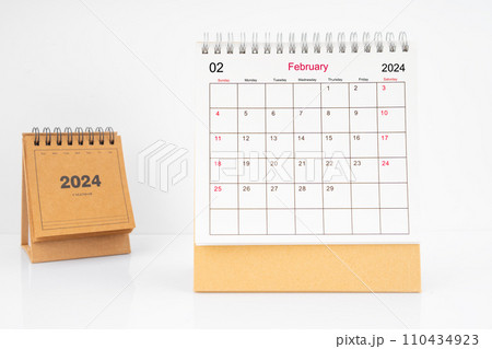 Monthly desk calendar February 2024 year on white table. 110434923