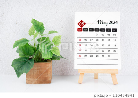 May 2024 calendar page and wooden plant pot. May 2024 calendar page and wooden plant pot. 110434941