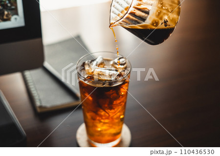 Iced coffee in a mug on the work desk at home 110436530