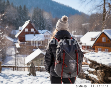 AI-generated content. Girl with a tourist backpack in the mountains in winter. AI 110437673