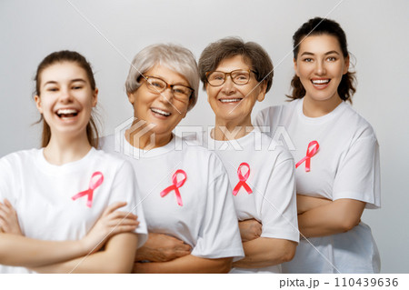 Smiling women with pink satin ribbon 110439636