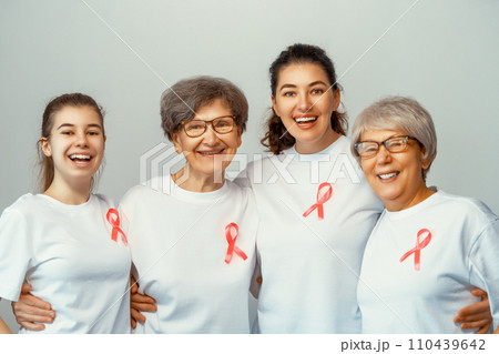 Smiling women with pink satin ribbon 110439642