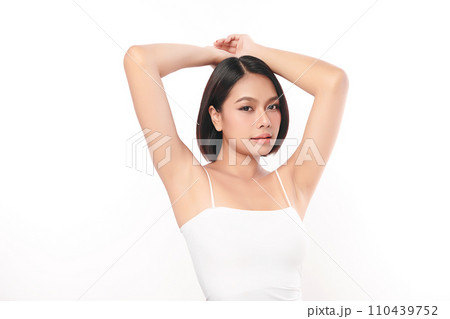 Beautiful Young Asian woman lifting hands up to show off clean and hygienic armpits or underarms on white background, Smooth armpit cleanliness and protection concept 110439752