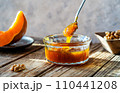 Autumn Harvest Pumpkin and walnuts Jam on wooden table, spoon with jam 110441208