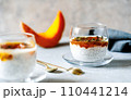Spiced Pumpkin Chia Parfait or pudding in a glass with ingredients over grey background 110441214