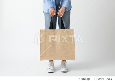 A woman holds a bag on a white background A woman holds a bag on a white background 110441783
