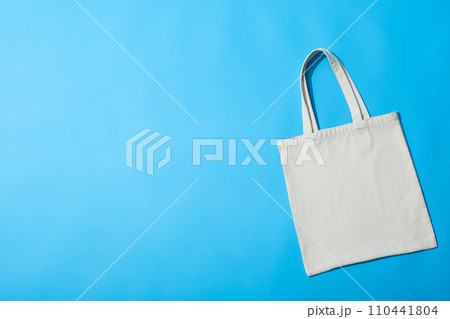 A white bag lies on a blue background A white bag lies on a blue background 110441804