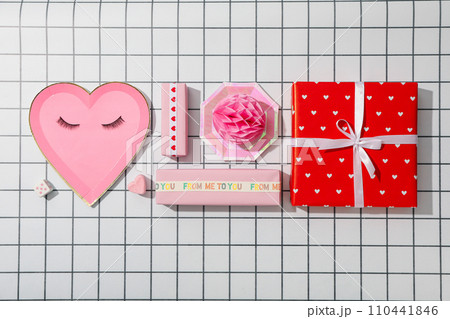Flat lay plate in the shape of a heart on a pink background. 110441846