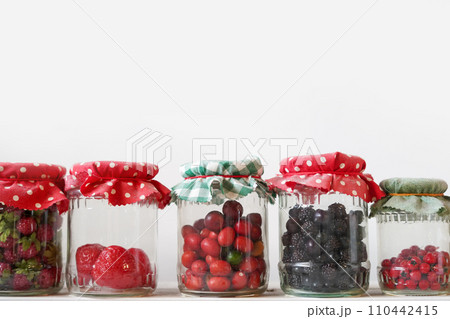 storing food vegetables, fruits in glass jars, white background, copy space storing food vegetables, fruits in glass jars, white background, copy space 110442415