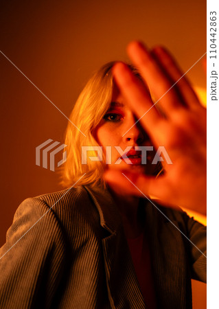 Vertical view of fashionable portrait of blonde lady in sunglasses posing.  110442863