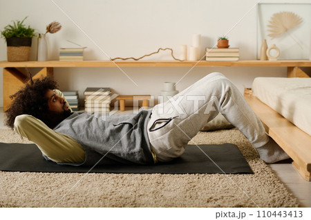 Active young man doing sit ups Active young man doing sit ups 110443413