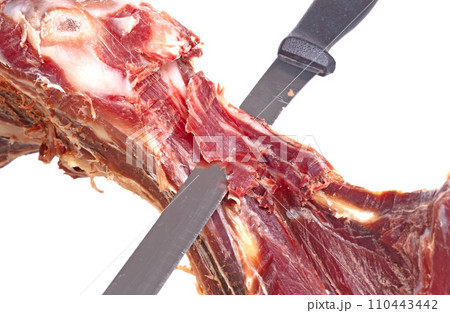 Leg of spanish jamon serrano, dry cured ham, on a white background Leg of spanish jamon serrano, dry cured ham, on a white background 110443442