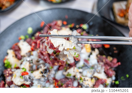Korean food. Sliced raw beef and live octopus Korean food. Sliced raw beef and live octopus 110445201