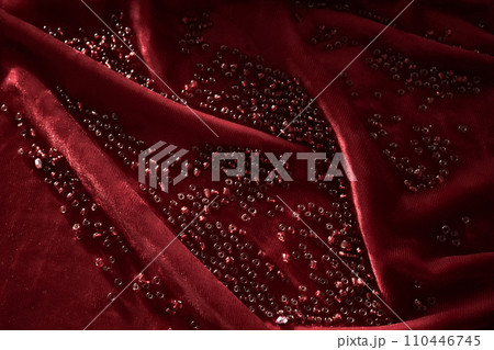 Abstract background from red beads on red velvet. 110446745