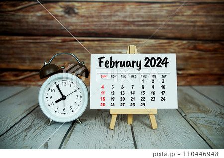 February 2024 monthly calendar on easel stand on wooden background 110446948