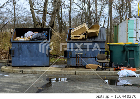 Metal garbage bins used to contain household waste during house renovations 110448270