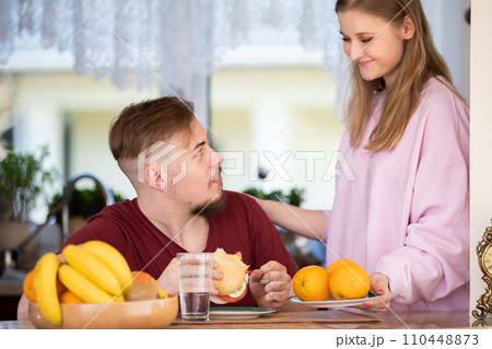 Eating a healthy meal in the kitchen in the morning. 110448873