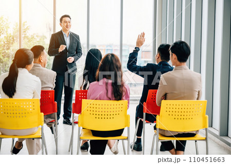 In a conference, hands are raised for questions, symbolizing audience participation and interactive learning. A diverse group collaborates at a workshop or seminar, promoting teamwork and discussion. In a conference, hands are raised for questions, symbolizing audience participation and interactive learning. A diverse group collaborates at a workshop or seminar, promoting teamwork and discussion. 110451663