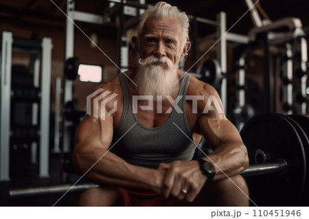 Elderly pensioner old man smiling in gym. 60-70 Year Old Bodybuilder. Elderly pensioner old man smiling in gym. 60-70 Year Old Bodybuilder. 110451946