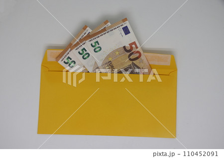 banknotes in a yellow envelope. open envelope with banknotes on a light background. envelope with banknotes. close up of an envelope with cash. international currency banknote. Euro dollars rubles. banknotes in a yellow envelope. open envelope with banknotes on a light background. envelope with banknotes. close up of an envelope with cash. international currency banknote. Euro dollars rubles. 110452091