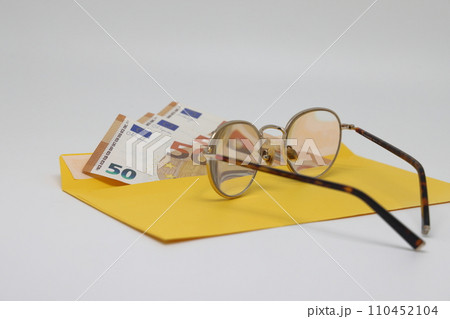 banknotes in a yellow envelope. open envelope with banknotes on a light background. envelope with banknotes. close up of an envelope with cash. international currency banknote. Euro dollars rubles. banknotes in a yellow envelope. open envelope with banknotes on a light background. envelope with banknotes. close up of an envelope with cash. international currency banknote. Euro dollars rubles. 110452104