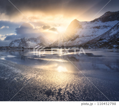 Beautiful snowy mountains and colorful sky with clouds at sunrise 110452798