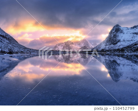 Beautiful snowy mountains and colorful sky with clouds at sunrise 110452799