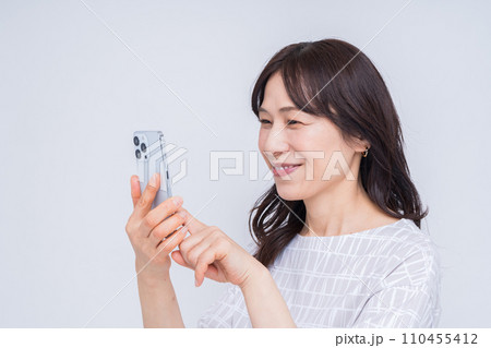 スマホを操作するミドル女性。 110455412