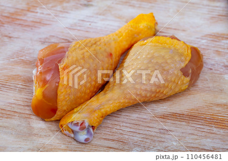 Raw chicken hams before cooking with greens and garlic 110456481