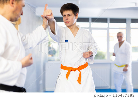 Adult and young men training karate fight 110457395