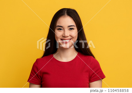Portrait of attractive young asian woman posing on yellow background 110458858