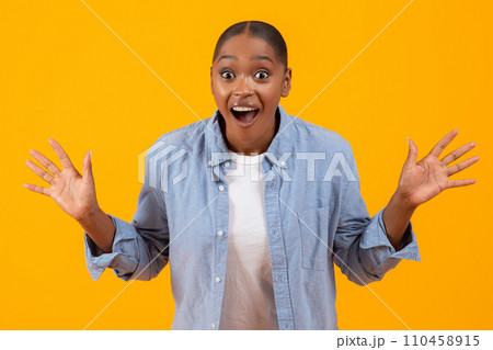 Joyful Black Lady Shouting Omg In Excitement Against Yellow Background Joyful Black Lady Shouting Omg In Excitement Against Yellow Background 110458915
