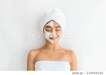 Woman with half-face mask enjoys spa day Woman with half-face mask enjoys spa day 110459182